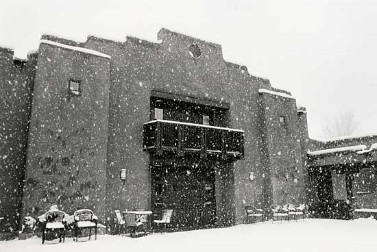 building with heavy snow falling